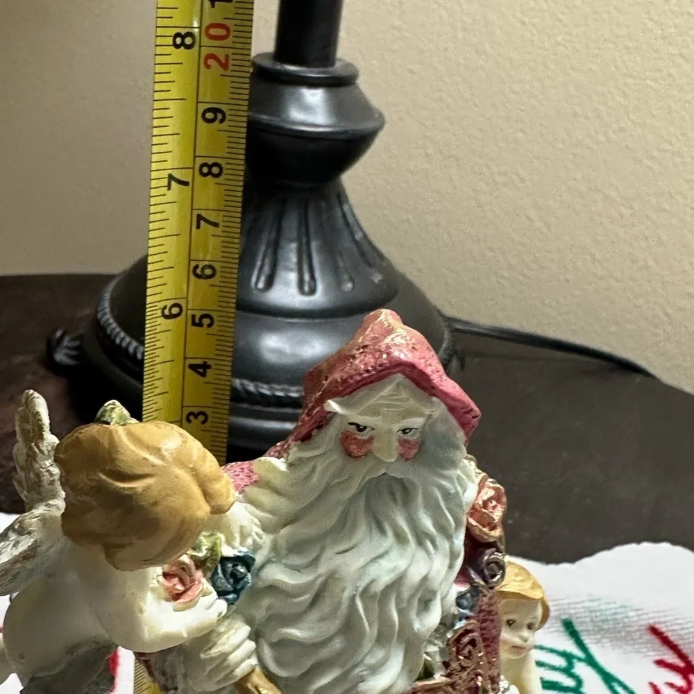 Festive Santa Figurine with Cherubs